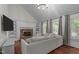 Bright living room with vaulted ceilings, fireplace, built-in shelving, and comfortable seating, perfect for relaxation and entertaining at 6904 Sandringham Dr, Raleigh, NC 27613