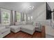 Spacious living room with ample natural light, a comfortable sectional sofa, and stairs leading to the second floor at 6904 Sandringham Dr, Raleigh, NC 27613