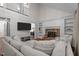 Open-concept living room with a brick fireplace, built-in bookshelves, and a large sectional sofa perfect for gatherings at 6904 Sandringham Dr, Raleigh, NC 27613