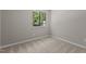 Bedroom featuring neutral walls, carpet, and natural light through the window at 7407 Sandy Creek Dr, Raleigh, NC 27615