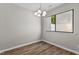 Well-lit dining area with wood-look floors, neutral walls, and a window view at 7407 Sandy Creek Dr, Raleigh, NC 27615