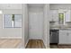 Bright entryway featuring wood-look flooring, neutral walls, and a view into the kitchen at 7407 Sandy Creek Dr, Raleigh, NC 27615