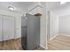 Spacious kitchen with stainless steel refrigerator, white cabinets, and wood-look floors at 7407 Sandy Creek Dr, Raleigh, NC 27615