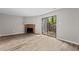 Bright living room featuring a stone fireplace, vinyl floors, and a sliding glass door to the backyard at 7407 Sandy Creek Dr, Raleigh, NC 27615