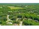 Aerial view showcasing homes nestled among lush green trees and a golf course at 7544 Hasentree Club Dr, Wake Forest, NC 27587