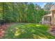 Well-maintained backyard features a fenced perimeter, and lush lawn at 7544 Hasentree Club Dr, Wake Forest, NC 27587