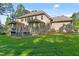 View of the home's exterior and backyard with a raised wooden deck at 7544 Hasentree Club Dr, Wake Forest, NC 27587