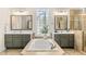 Bright bathroom featuring a soaking tub, double vanities, and glass block window for natural light at 7544 Hasentree Club Dr, Wake Forest, NC 27587