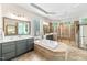 Bathroom features a soaking tub, double vanities, a glass block window, and a glass-enclosed shower at 7544 Hasentree Club Dr, Wake Forest, NC 27587