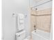 Well-lit bathroom featuring a tiled shower and a convenient towel rack at 7544 Hasentree Club Dr, Wake Forest, NC 27587