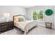 Bedroom featuring a neutral color scheme, a window with natural light, and dark wood furniture at 7544 Hasentree Club Dr, Wake Forest, NC 27587