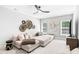 Bonus room featuring a large sectional sofa, a ceiling fan, and ample windows at 7544 Hasentree Club Dr, Wake Forest, NC 27587