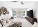 Bonus room featuring a large sectional sofa, a ceiling fan, and ample windows at 7544 Hasentree Club Dr, Wake Forest, NC 27587