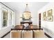 Formal dining room featuring a dark wood table, comfortable chairs, and an elegant chandelier at 7544 Hasentree Club Dr, Wake Forest, NC 27587