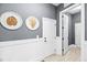 Entryway features white wainscoting, gray walls, and framed botanical prints at 7544 Hasentree Club Dr, Wake Forest, NC 27587