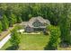 Aerial image of a two-story home with a lush lawn and mature trees at 7544 Hasentree Club Dr, Wake Forest, NC 27587