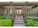 Inviting front entrance with a stone pathway, decorative plants, and a stylish double-door entry at 7544 Hasentree Club Dr, Wake Forest, NC 27587