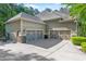 Three-car garage showcasing decorative doors and a spacious driveway at 7544 Hasentree Club Dr, Wake Forest, NC 27587