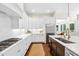 Bright kitchen featuring white cabinetry, stainless steel appliances, and a spacious center island with a sink at 7544 Hasentree Club Dr, Wake Forest, NC 27587