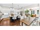 Modern kitchen with white cabinets, center island, stainless appliances, and an eat-in breakfast area at 7544 Hasentree Club Dr, Wake Forest, NC 27587