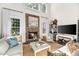 Inviting living room features a stone fireplace, high ceilings, natural light, and cozy furnishings at 7544 Hasentree Club Dr, Wake Forest, NC 27587