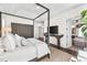 Main bedroom features a wood-framed bed, a TV on a credenza, and access to the bathroom at 7544 Hasentree Club Dr, Wake Forest, NC 27587