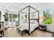 Bright main bedroom with wood-framed bed, ceiling fan, and shiplap walls at 7544 Hasentree Club Dr, Wake Forest, NC 27587