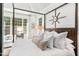 Bright main bedroom features shiplap walls, a wood-framed bed, and an armchair near the windows at 7544 Hasentree Club Dr, Wake Forest, NC 27587