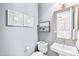 Gray powder room featuring a gold framed mirror and fixtures, and a white sink at 7544 Hasentree Club Dr, Wake Forest, NC 27587