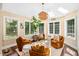 Cozy sunroom with natural light, unique decor, comfortable seating, and inviting ambiance at 7544 Hasentree Club Dr, Wake Forest, NC 27587