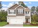 Charming two-story home with a two-car garage, manicured lawn and contrasting architectural features at 815 Rhino Bnd, Oxford, NC 27565