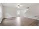 Bright and open living space with wood-look floors, large windows, and a ceiling fan at 815 Rhino Bnd, Oxford, NC 27565