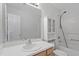Neutral bathroom features a vanity, mirror, cabinets, and a tub and shower with a shower head at 8721 Springhouse Ln, Raleigh, NC 27617