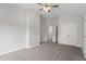 Empty bedroom with neutral carpet and walls and ceiling fan at 8721 Springhouse Ln, Raleigh, NC 27617