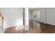 Bright dining room with hardwood floors, modern lighting, and large windows for natural light at 8721 Springhouse Ln, Raleigh, NC 27617