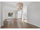 Spacious dining room featuring hardwood floors, arched doorways, and stairs to the second floor at 8721 Springhouse Ln, Raleigh, NC 27617