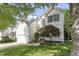 Two-story home with white siding, an attached garage, and beautiful front yard landscaping at 8721 Springhouse Ln, Raleigh, NC 27617