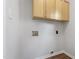 Convenient laundry room with overhead storage and utility connections at 8721 Springhouse Ln, Raleigh, NC 27617