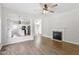 Living room with hardwood floors, fireplace, and open access to kitchen at 8721 Springhouse Ln, Raleigh, NC 27617