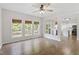Bright living room features hardwood floors, large windows, and access to kitchen at 8721 Springhouse Ln, Raleigh, NC 27617
