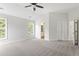 Spacious main bedroom with vaulted ceiling, carpeted floor, and ensuite bathroom at 8721 Springhouse Ln, Raleigh, NC 27617
