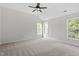 Bright bedroom offers neutral carpet, vaulted ceiling, and natural light at 8721 Springhouse Ln, Raleigh, NC 27617