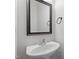 This powder room features a pedestal sink, framed mirror, and brushed nickel hardware at 8721 Springhouse Ln, Raleigh, NC 27617