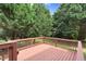 Large wooden back deck surrounded by mature trees, offering a private outdoor retreat at 8820 Waynick Dr, Raleigh, NC 27617