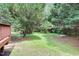 Spacious backyard features lush greenery and a wooden deck at 8820 Waynick Dr, Raleigh, NC 27617