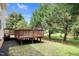 Inviting backyard features a wooden deck and mature trees at 8820 Waynick Dr, Raleigh, NC 27617