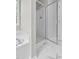 Modern bathroom with tub, shower, neutral paint, tile floors and updated fixtures at 8820 Waynick Dr, Raleigh, NC 27617