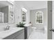 Beautiful bathroom featuring double vanities, marble floors, a window and updated fixtures at 8820 Waynick Dr, Raleigh, NC 27617