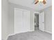 This bedroom features neutral walls, carpet flooring, a closet and entrance to another room at 8820 Waynick Dr, Raleigh, NC 27617