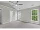 Bright bedroom featuring vaulted ceiling, ceiling fan, neutral paint and large windows at 8820 Waynick Dr, Raleigh, NC 27617